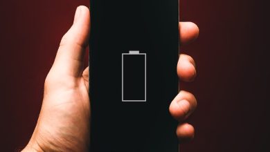 person holding low battery smartphone